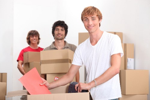 Local packing team helping with fragile items and labelled boxes